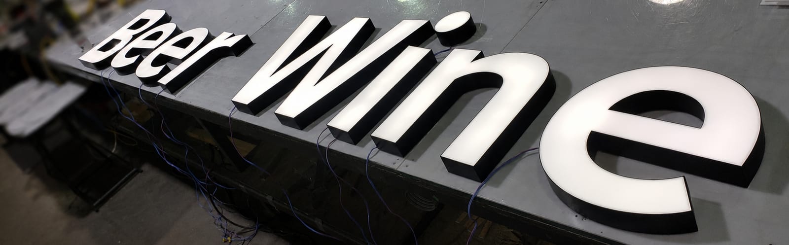 Illuminated trimless channel letters reading Beer Wine, produced for a department within the supermarket expansion