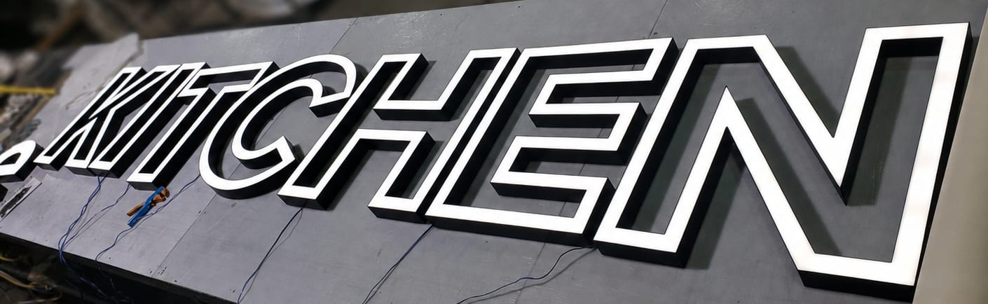 Illuminated trimless channel letters reading Kitchen, produced for a department within the supermarket expansion